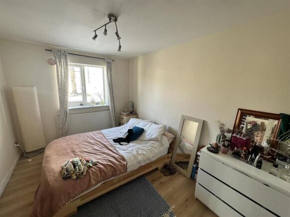 Bright double room with bed and storage...