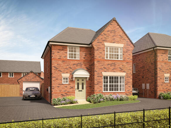 A modern brick house with a light green door and manicured bushes in the foreground is set against a