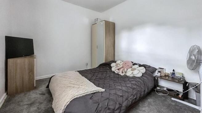 A spacious and well-maintained master bedroom f...