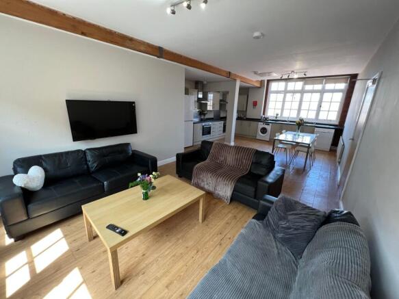 Bright and spacious living room featuring comfo...