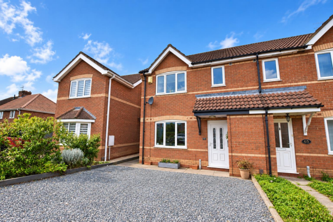 Sunny UK Brick Terrace with Gravel Driveway.png