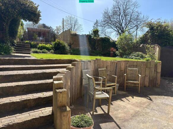 Patio and steps up to further garden area