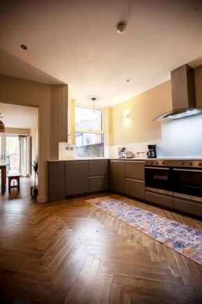Spacious modern kitchen with wooden floors...