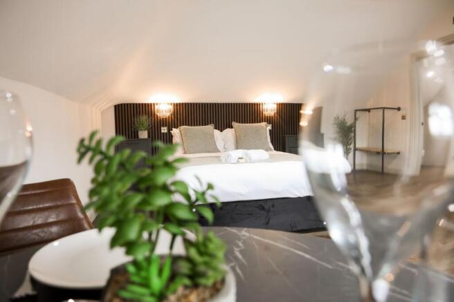 Stylish double bedroom with modern headboard...