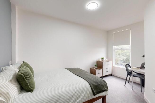 A bright and comfortable double bedroom featuri...