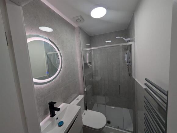 Modern bathroom with chic LED mirror and shower...