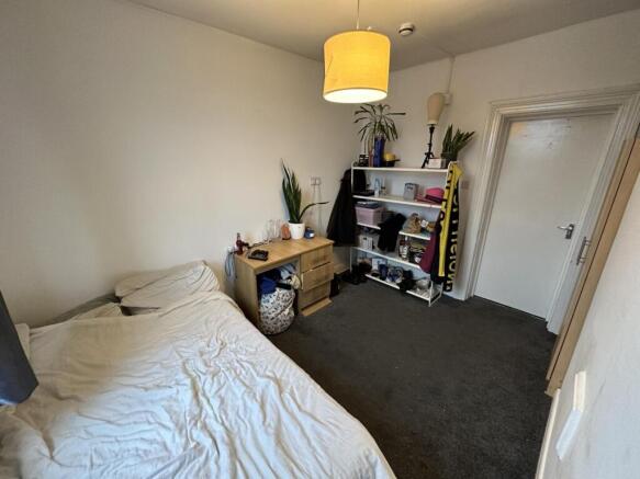 Comfortable bedroom with desk and ample storage...