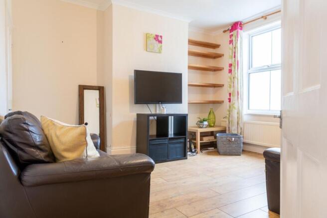 Bright, well-kept living room with a wall-mount...