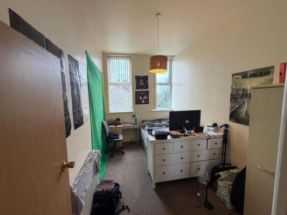 Bright bedroom with desk and ample storage...