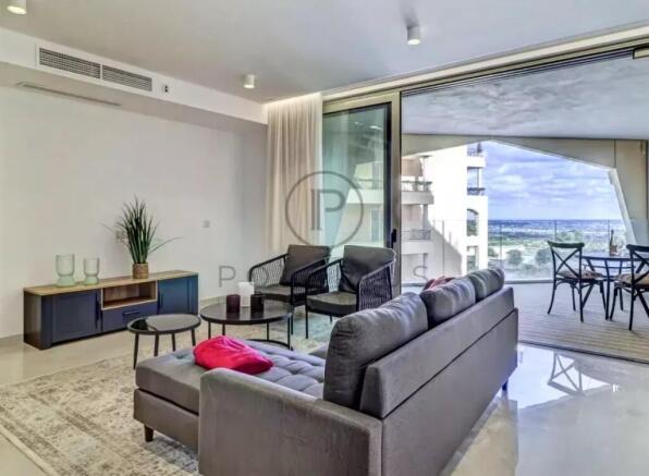 A modern living room with a gray sofa, several cha