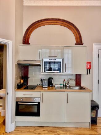 Compact modern kitchen with wooden worktop...