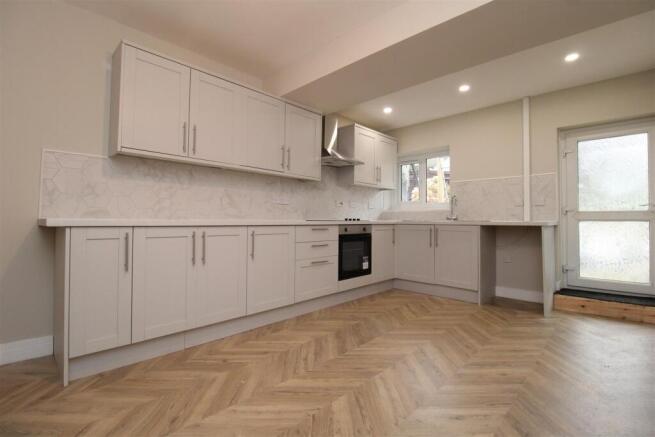 Bright modern kitchen with herringbone floors...