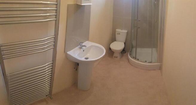 Bright, well-kept bathroom with a pedestal sink...