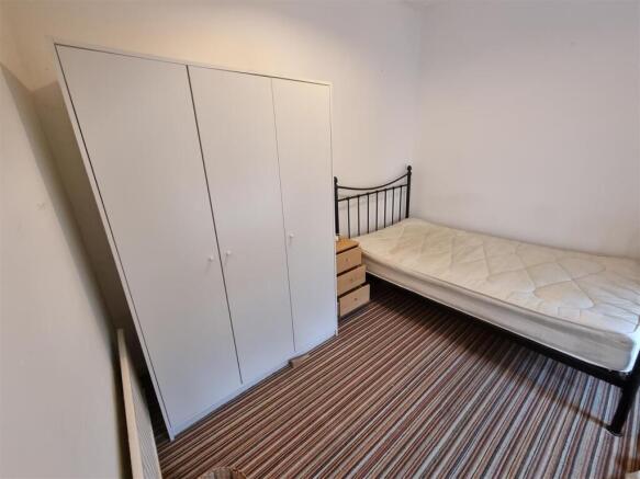 Bright bedroom with ample storage and sleek bed...