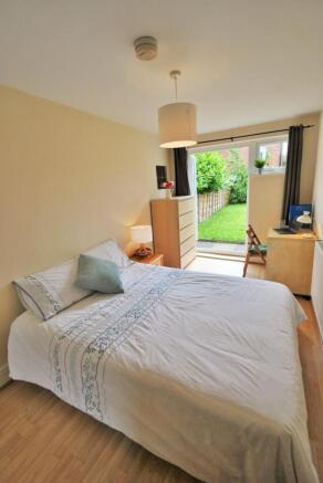 Bright bedroom with double bed and garden acces...