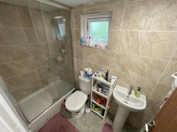 A modern bathroom featuring a spacious shower e...