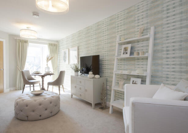 a living room with a white couch and a white table
