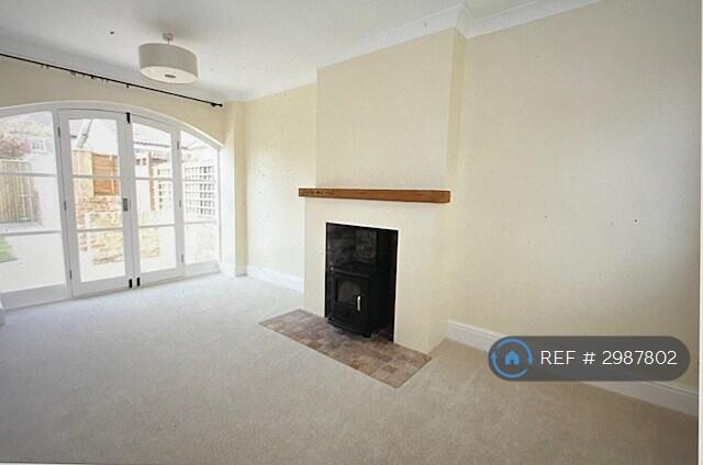 Sitting Room With French Windows And Log Burner.  