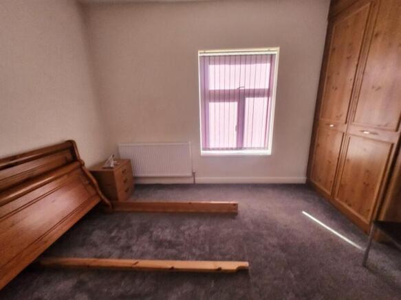 Bright double bedroom with a large fitted wardr...