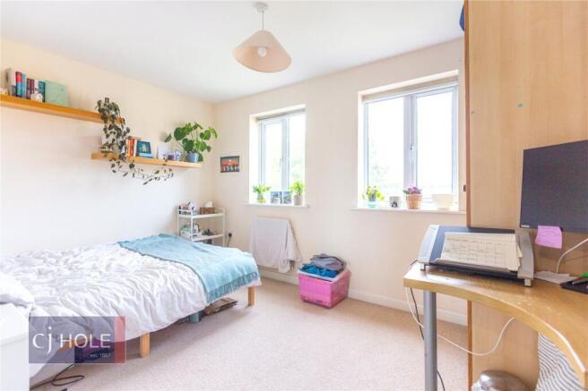 A bright and cozy single bedroom featuring two ...