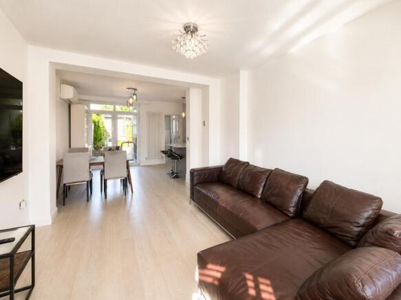Spacious open-plan living room with sofa...
