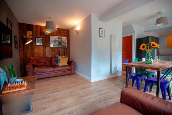 Bright lounge with dining area and wooden floor...