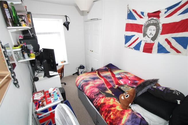 Bright bedroom with desk and built-in storage...