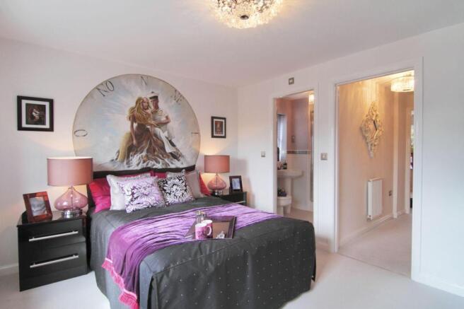 The master bedroom features an en suite shower room