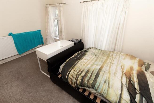 Bright bedroom with double bed and desk area...