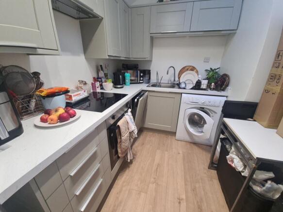 Bright, modern kitchen with light cabinets, int...