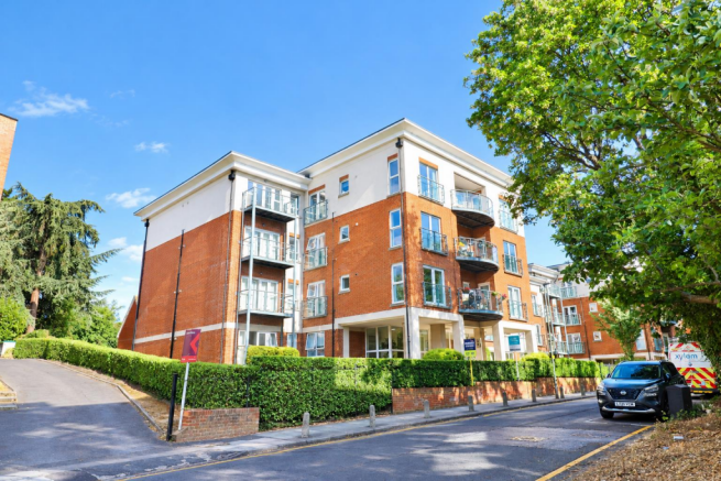 Sunlit Modern Apartment Block with Greenery.png
