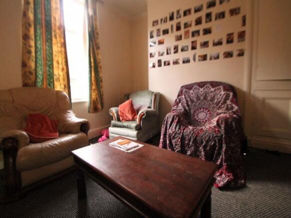 A cozy living room featuring a comfortable sofa...