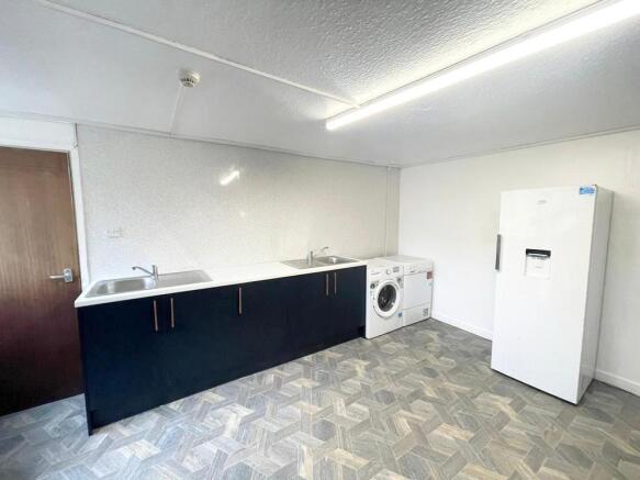Spacious laundry area with modern appliances...