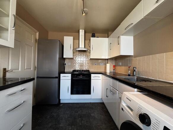 Modern kitchen with appliances and ample storag...