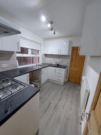 Modern galley kitchen with sleek white cabinets...