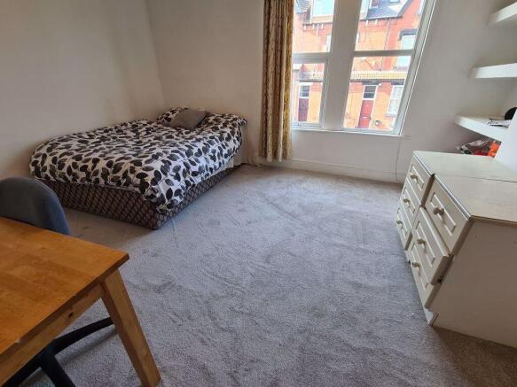 A cozy and well-maintained bedroom featuring a ...