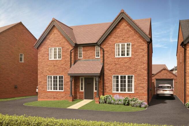 A modern brick house with a manicured lawn and flowerbeds in the foreground sits under a partly clou