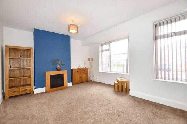 A bright and spacious living room featuring lar...