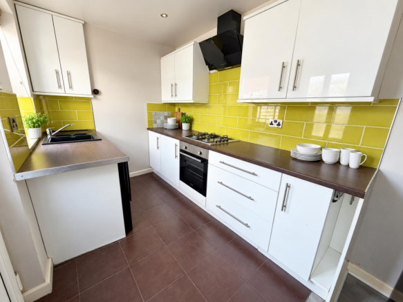 Brightened kitchen with white ceramics and herb-1.