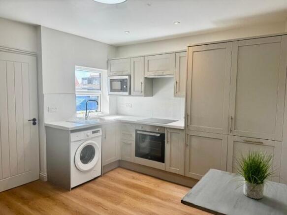 Modern fitted kitchen with sleek appliances...