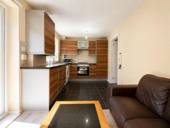 Modern open-plan kitchen with smart wood finish...
