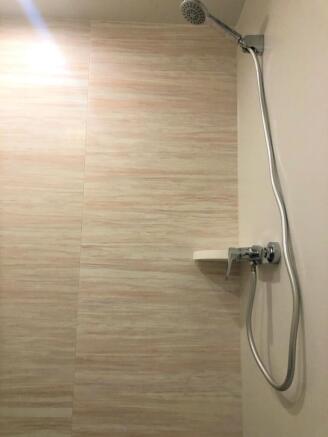 A clean, modern shower area featuring a sleek c...