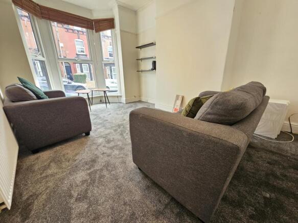 Bright and welcoming living room with large win...