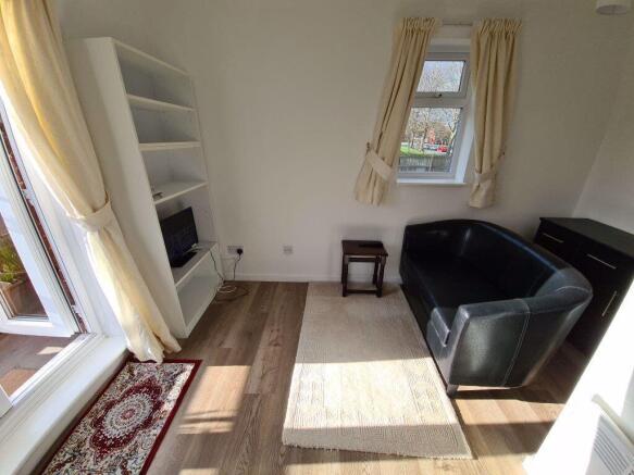 A bright and tidy living room featuring natural...