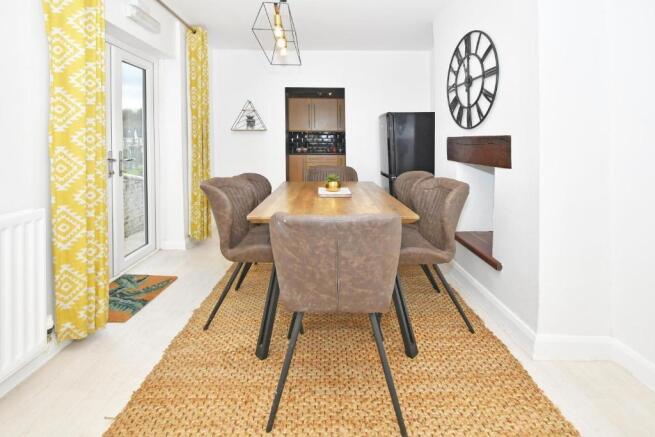 Bright, modern dining area with a wooden table ...