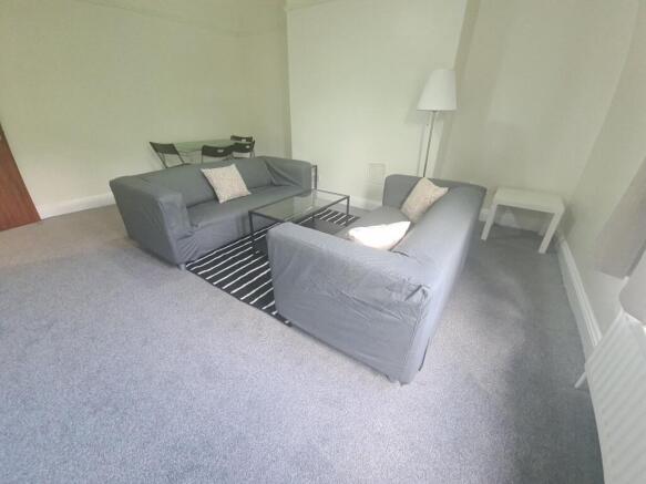 A bright and inviting living room featuring com...