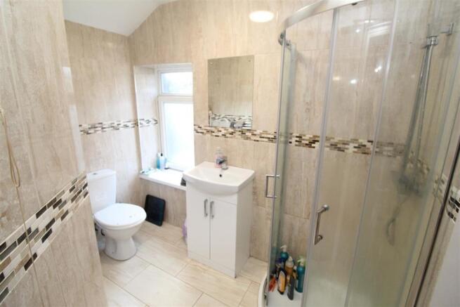 Bright modern bathroom with sleek corner shower...