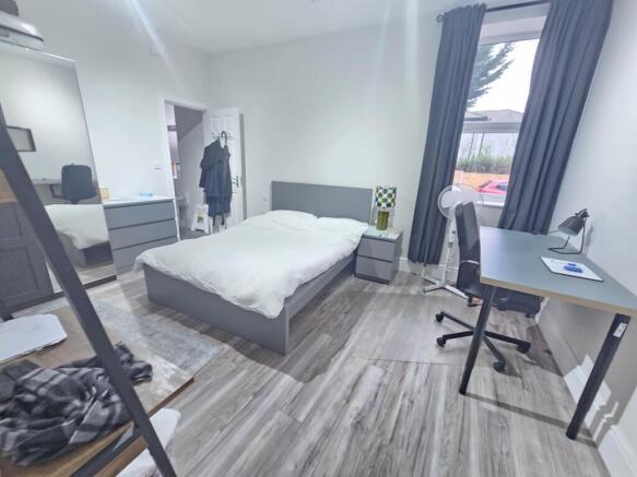 A bright and spacious master bedroom featuring ...