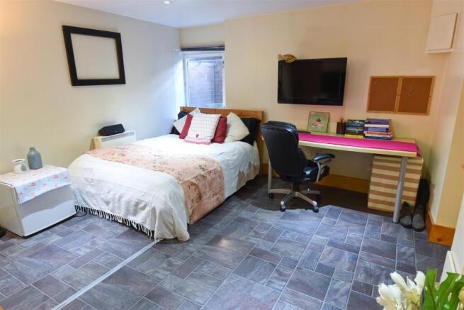 Spacious bedroom with double bed and large desk...