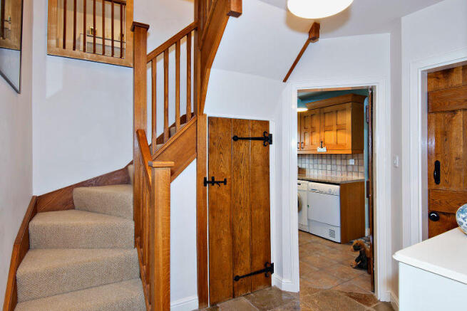 Oak stairway off living/dining area leading to lau